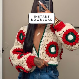 May include: A crochet cardigan pattern with a 3D sunburst design. The cardigan has a cream base with red and green floral accents. The text "3D SUNBURST CARDIGAN PATTERN" and "INSTANT DOWNLOAD" are visible.