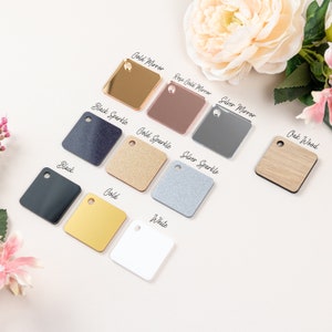 May include: A variety of 10 different square acrylic samples, including gold mirror, rose gold mirror, silver mirror, black sparkle, gold sparkle, silver sparkle, black, gold, white, and oak wood.