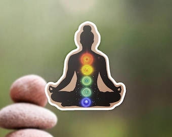 May include: A sticker of a person in a yoga pose with seven colorful chakras along their spine. The chakras are red, orange, yellow, green, blue, indigo, and violet.