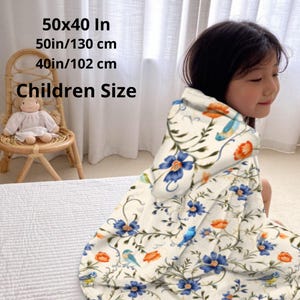 Hooded blue blanket personalised  with your name in a white bold letters.