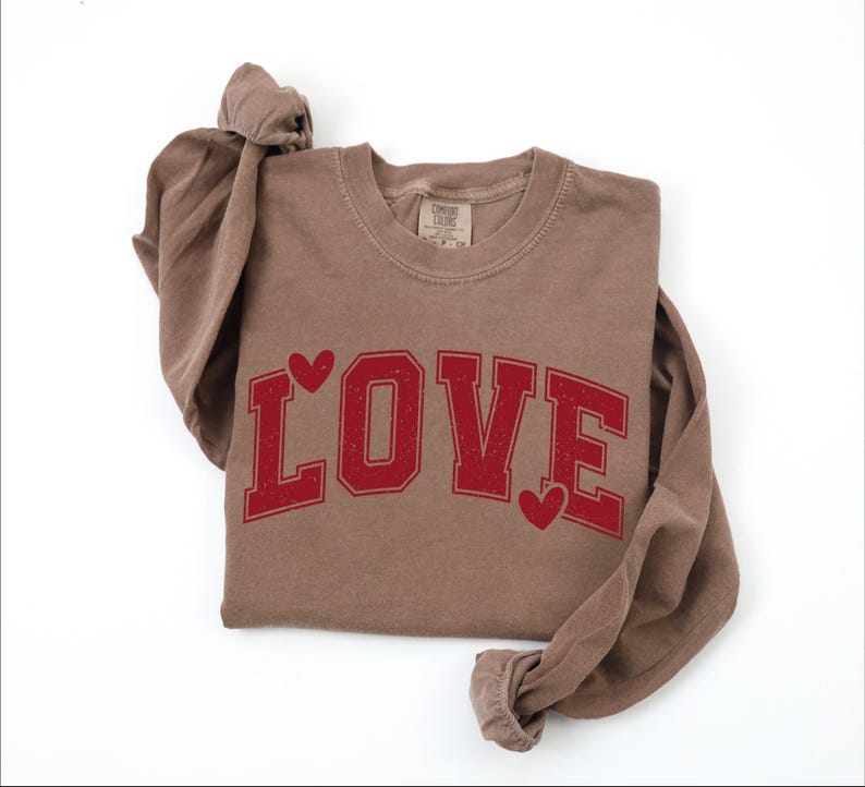 A brown long-sleeved t-shirt with the word "LOVE" printed in red letters.