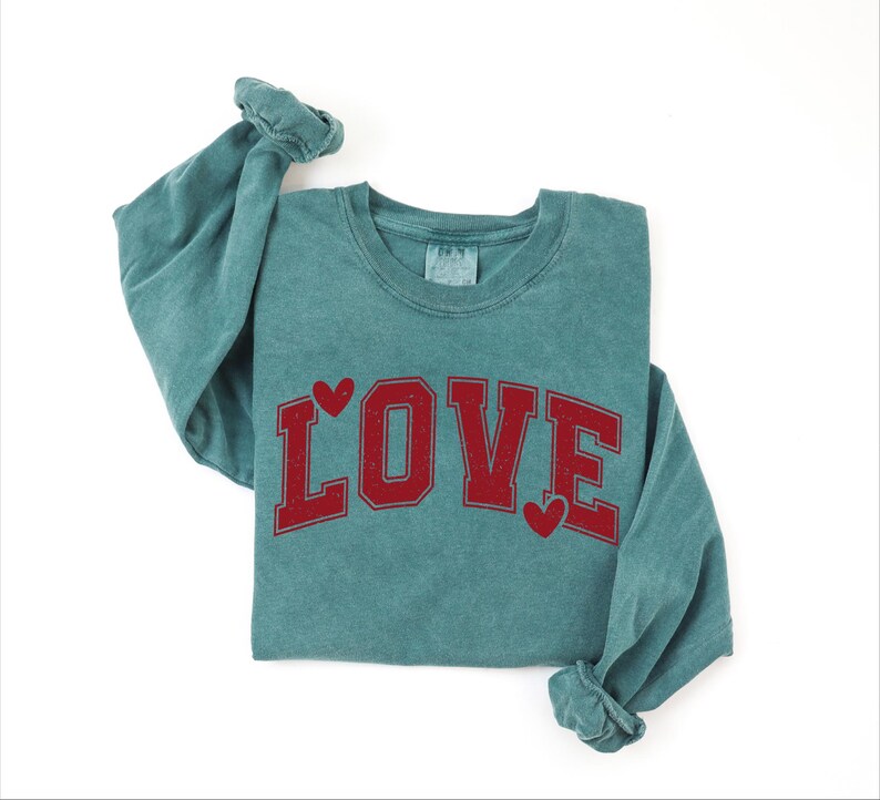 A green long-sleeved shirt with the word "LOVE" printed in red letters.
