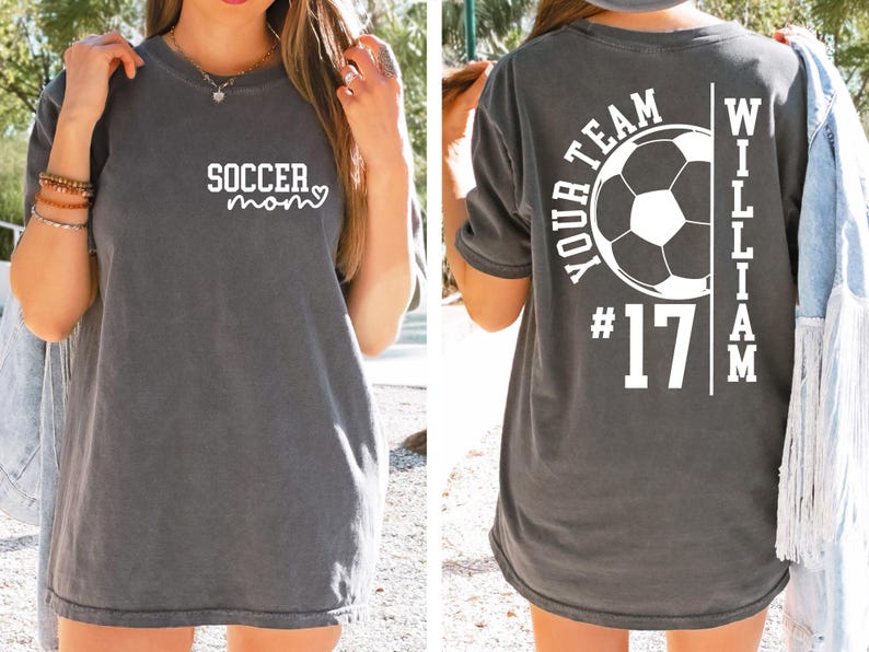 May include: Dark gray t-shirt with the text "soccer mom" in white on the front. The back of the shirt features a soccer ball graphic, the words "YOUR TEAM", the number "17", and the name "WILLIAM".