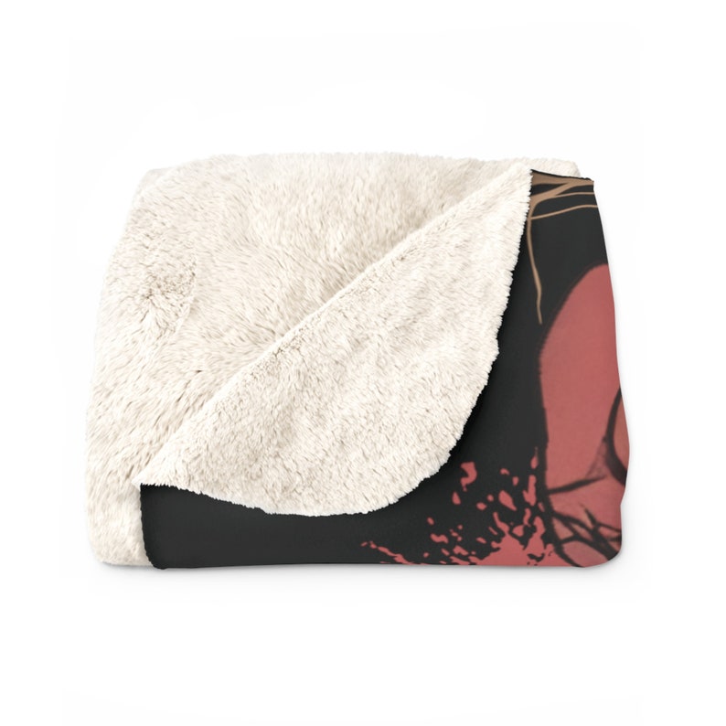 May include: A soft, plush throw blanket with a black and red abstract design. The blanket has a white sherpa lining.