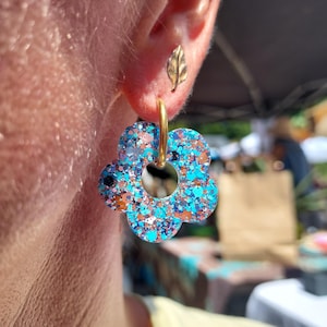 Creole earrings and small resin flower with multicolored sequins. Handmade jewelry for women.