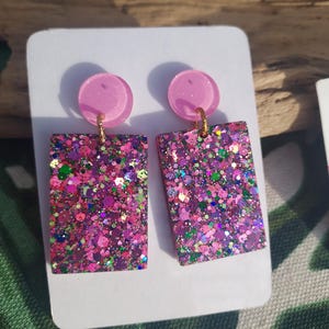 May include: A set of three ceramic mugs with a speckled, matte finish. The mugs are in shades of cream, light gray, and dark gray. Each mug has a simple, minimalist design, perfect for coffee or tea.