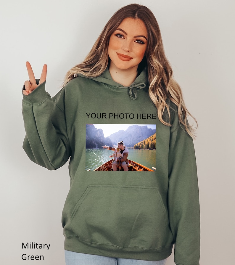 May include: A green hooded sweatshirt with a photo of a couple in a boat on a lake. The text "YOUR PHOTO HERE" is printed above the photo.