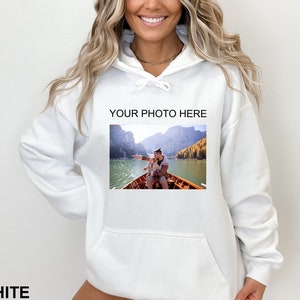 May include: White hooded sweatshirt with a pocket and the text "YOUR PHOTO HERE" printed on the front. The sweatshirt features a photo of a man and a child in a boat on a lake.
