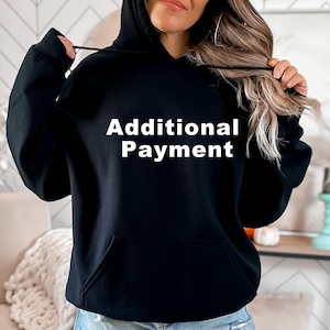 May include: Black hooded sweatshirt with the text "Additional Payment" in white lettering.