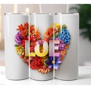 May include: Three white stainless steel tumblers with a floral design in the shape of a heart. The word "LOVE" is spelled out in the center of the heart using colorful letters.