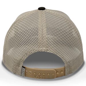 May include: A tan and black trucker hat with a mesh back and a curved brim. The hat has a black button on top and a tan adjustable snap closure. The word "LOST" is printed on the back.