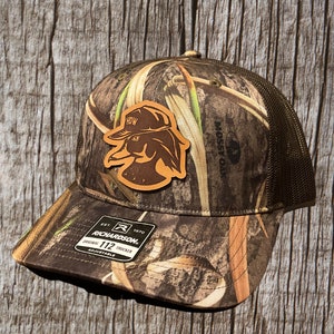 Leather Patch Trucker Hat - Mossy Oak Habitat/ Brown Richardson 112 - HDW Wood Duck Logo