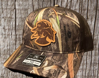 Leather Patch Trucker Hat - Mossy Oak Habitat/ Brown Richardson 112 - HDW Wood Duck Logo