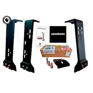 May include: Black roof rack components, including brackets, bolts, and a mounting plate, are displayed against a white background. The image includes a cardboard box and a brochure. The brand name "ozrooffracks" is visible.
