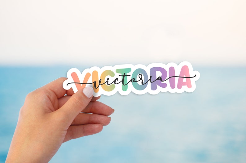 May include: A rainbow-colored vinyl sticker with the name "VICTORIA" written in a cursive font.