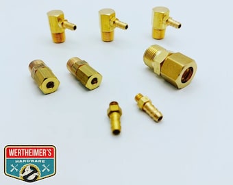 May include: Assortment of brass fittings for plumbing or air lines. The fittings include 90-degree elbows, straight connectors, and hose barb adapters.