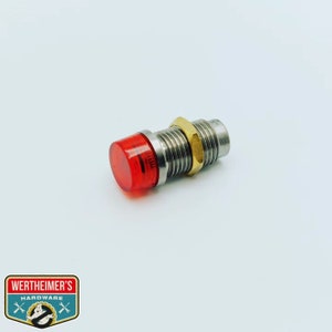 May include: A red LED indicator light with a metal housing and a brass nut. The light is designed for use in electrical circuits.