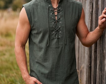 May include: Olive green sleeveless shirt with a lace-up front. The shirt has a mandarin collar and a relaxed fit. The fabric appears to be linen or a similar lightweight material. The shirt is a solid color and suitable for casual wear.