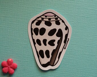 May include: A black and white spotted seashell sticker with a pink interior. The sticker has a brown outline and the text '@cococonulgal' on the right side.