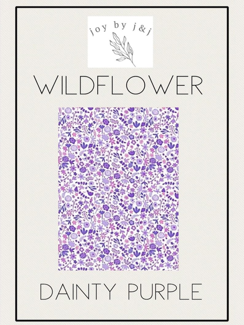 May include: A rectangular design featuring a floral pattern in shades of purple and white, with the words "WILDFLOWER" and "DAINTY PURPLE" in a minimalist font. The design is framed by a black border, with the text "joy by j&j" at the top.