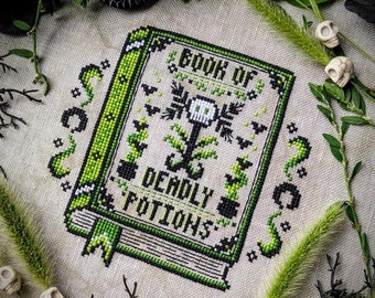 May include: A cross-stitch pattern of a book titled "Book of Deadly Potions". The book cover features a skull with a plant growing out of it, surrounded by bats and other spooky details.