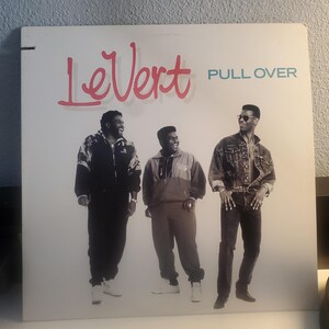 May include: A black and white album cover featuring a group of three men. The album cover is titled "LeVert PULL OVER".