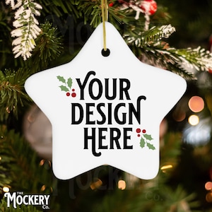 May include: White ceramic star-shaped Christmas ornament with a green holly sprig and red berries on each side. The ornament has black text that reads "YOUR DESIGN HERE".