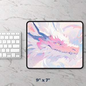 May include: A pink and white dragon mousepad with a black border. The dragon's face is visible, with a pink snout and yellow eye. The mousepad measures 9 inches by 7 inches.