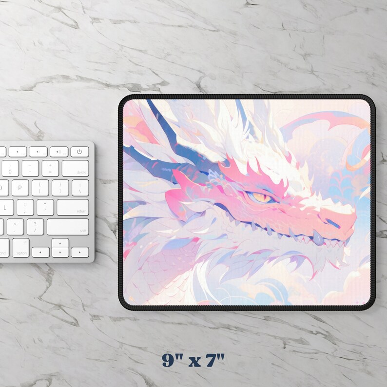 May include: A pink and white dragon mousepad with a black border. The dragon's face is visible, with a pink snout and yellow eye. The mousepad measures 9 inches by 7 inches.