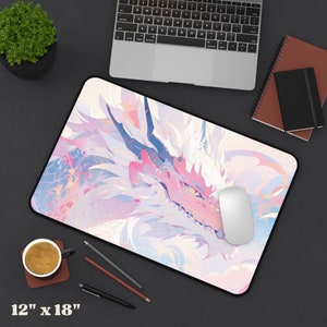 May include: A pink and white mousepad with a dragon design. The dragon's head is in the foreground, and its scales are visible. The mousepad is 12 inches by 18 inches.