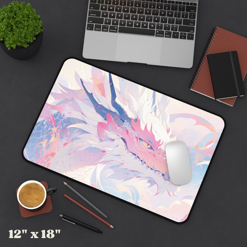May include: A pink and white mousepad with a dragon design. The dragon's head is in the foreground, and its scales are visible. The mousepad is 12 inches by 18 inches.