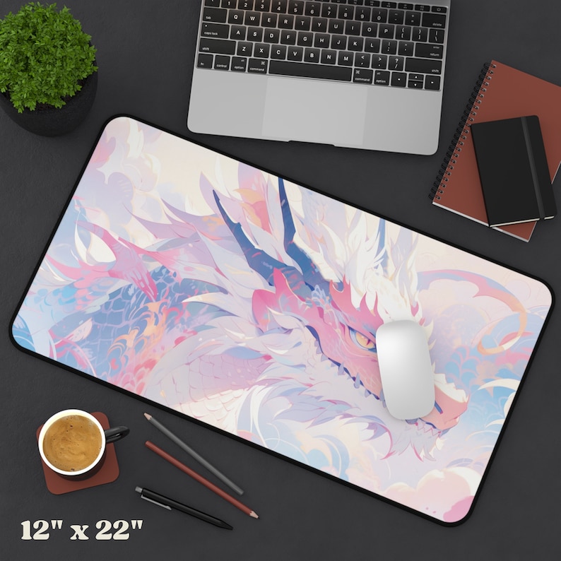 May include: A pink and white mousepad with a dragon design. The dragon is a light pink color with white accents and has a yellow eye. The mousepad is 12 inches by 22 inches.