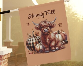 May include: A tan house flag with the words "Howdy Fall" in a script font. The flag features a Highland cow illustration with pumpkins and fall leaves. The cow is brown with long fur and large horns.