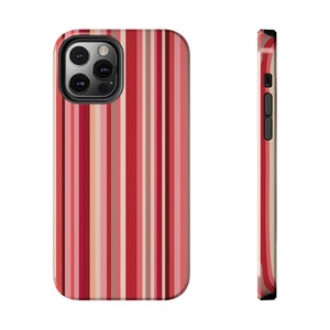May include: A red, white, and pink striped phone case for an iPhone with a camera cutout.