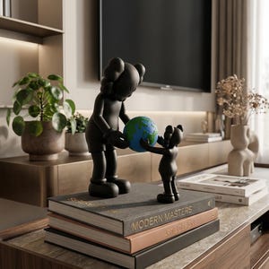 May include: A white ceramic mug with a black handle and the text "But First, Coffee" in a handwritten style. The mug is on a white surface. The mug is approximately 4 inches tall.