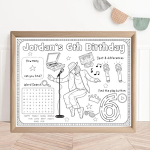 May include: A black and white activity sheet in a wooden frame, featuring the text "Jordan's 6th Birthday." The sheet includes a word search, a maze, and other activities with musical themes. The image includes a drawing of a person singing into a microphone.