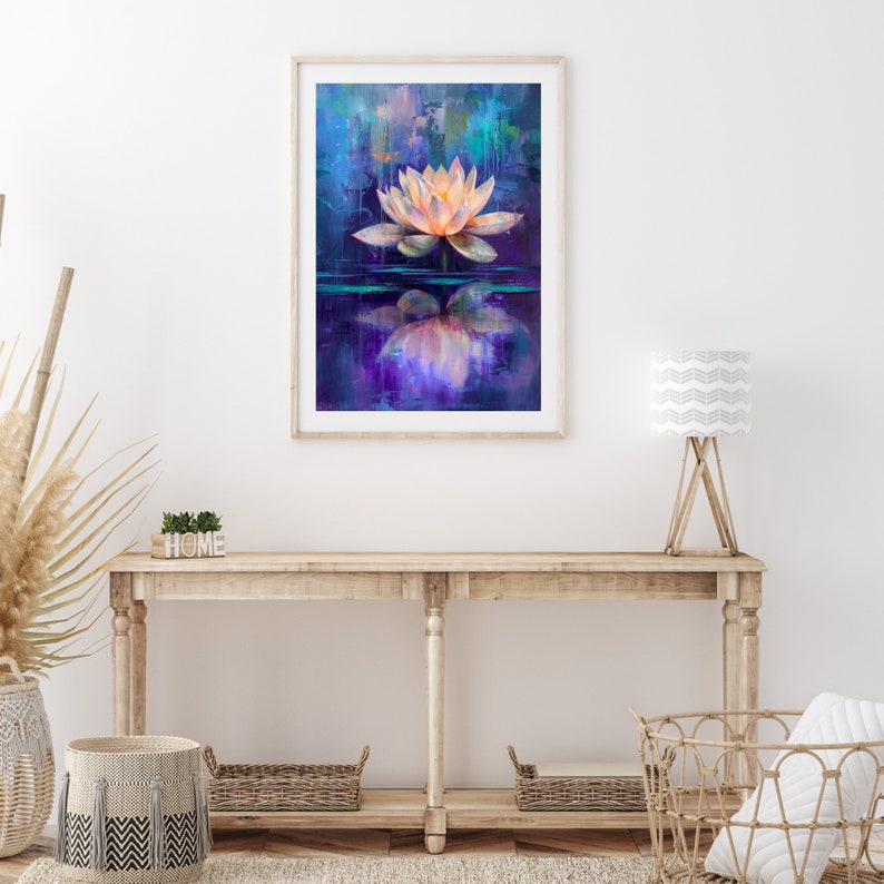 May include: A framed art print featuring a serene lotus flower floating on water. The artwork showcases a soft, glowing flower in shades of peach and white against a backdrop of blues and purples. The water reflects the flower, enhancing the tranquil scene.
