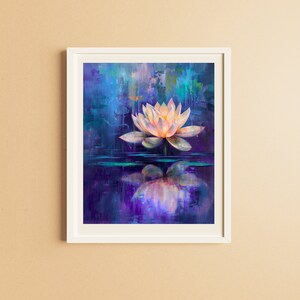 May include: A framed art print featuring a serene lotus flower painting. The artwork showcases a light pink and yellow lotus floating on water, with a vibrant blue and purple background. The painting is framed in a white border.