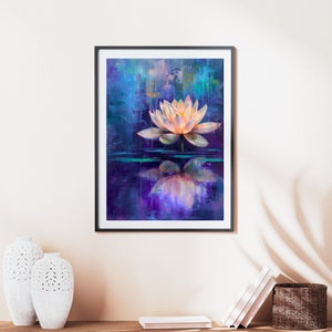 May include: Framed art print featuring a serene lotus flower floating on water. The painting uses a palette of blues, purples, and peach, with the flower's reflection mirrored below. The artwork is displayed on a beige wall.