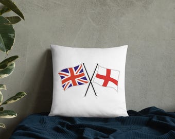 May include: White square pillow featuring two crossed flags. One flag is the Union Jack, the other is the St. George's Cross. The flags are in red, white, and blue. The pillow is on a dark blue surface.