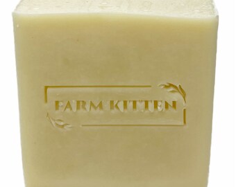 May include: A rectangular bar of off-white soap with the words "FARM KITTEN" embossed on the front.