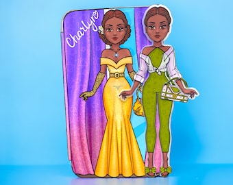 May include: Two paper dolls with brown skin and black hair. One doll is wearing a yellow gown with a gold belt and gold gloves. The other doll is wearing a green jumpsuit with a white shirt and a white handbag. The dolls are standing in front of a purple curtain with the name "Charlyn" written on it.