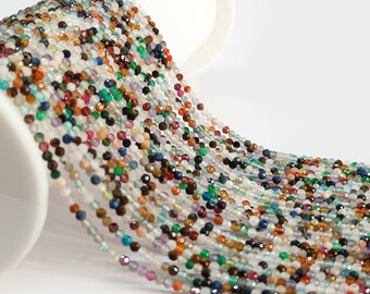 May include: A strand of colorful gemstone beads, featuring a variety of colors and shapes. The beads are small and uniform in size, creating a continuous strand of vibrant hues.
