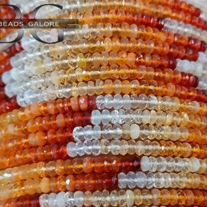 May include: A strand of multi-colored gemstone beads. The beads are small and round, and they are arranged in a repeating pattern of white, orange, and red. The beads are strung on a clear thread.