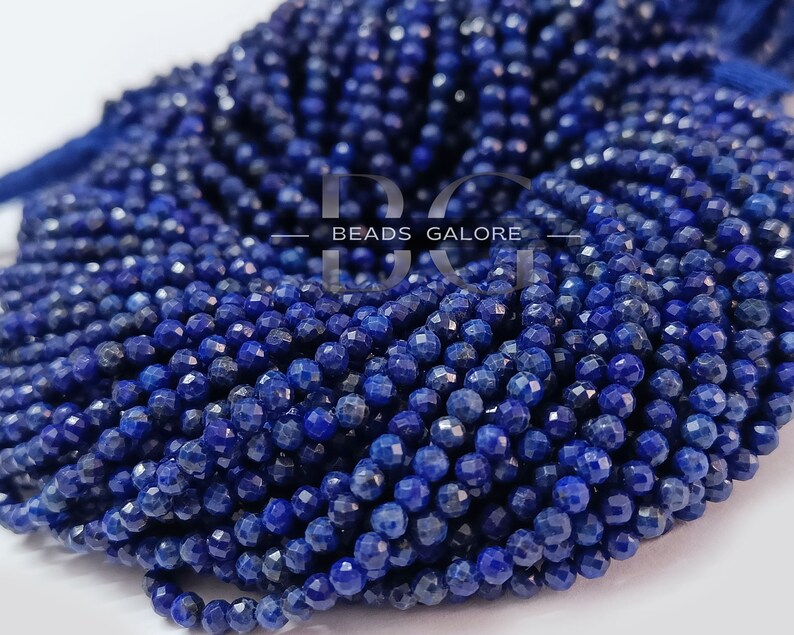 May include: A strand of deep blue lapis lazuli beads, each bead is faceted and measures approximately 4mm in diameter. The beads are strung on a clear thread and are ready to be used for jewelry making.