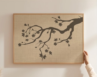 May include: A rectangular wall art piece featuring a dark brown silhouette of a flowering tree branch printed on a light tan, textured linen-like background. The artwork is encased in a simple, light-colored wooden frame with a clean edge.