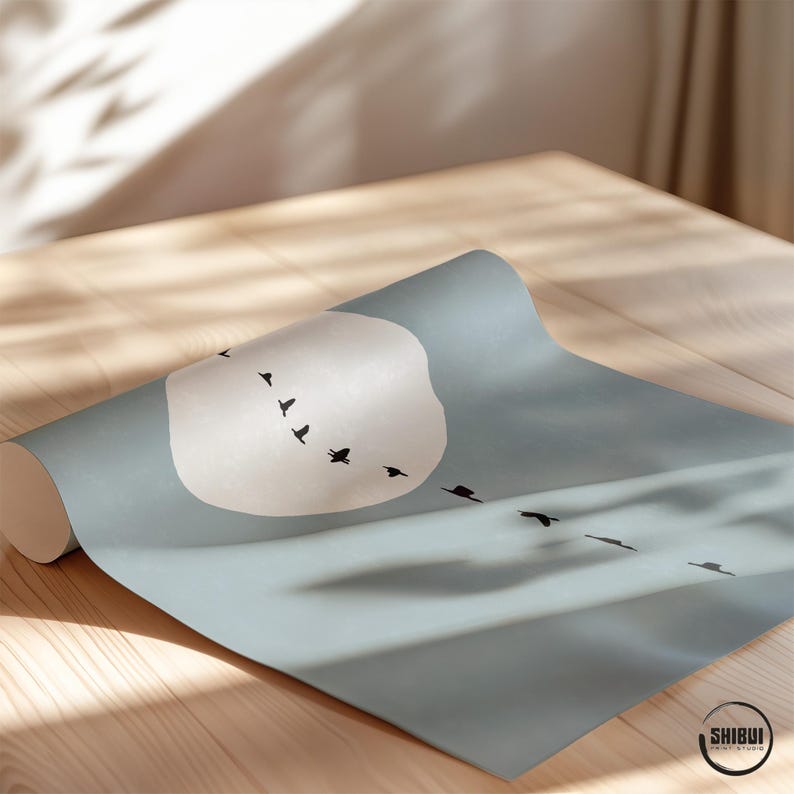 May include: A roll of light blue wallpaper featuring a large, pale circular moon and a flock of black birds flying in a diagonal formation. The bottom right corner displays a circular logo with the text SHIBUI PRINT STUDIO.