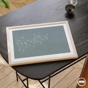 Horizontal art print displayed in minimalist office.