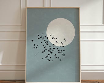May include: A framed wall art print featuring a large, pale beige circular moon set against a muted blue background. A flock of small, black bird silhouettes is scattered across the lower left portion of the print. The text SHIBUI is visible.