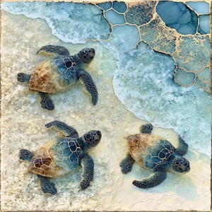 May include: A square wall art piece featuring three sea turtles on a sandy beach with ocean waves. The artwork uses shades of blue, teal, and tan with gold metallic veining throughout the water section, creating a textured, layered appearance.